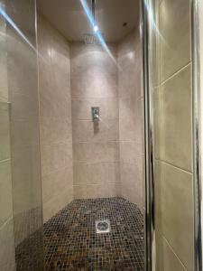 a shower with a glass door in a bathroom at The Loft St Austell in St Austell