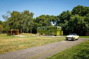 a car is parked in front of a trailer at The Showman's Carriage w King Bed close to beach in Birdham +33 photos