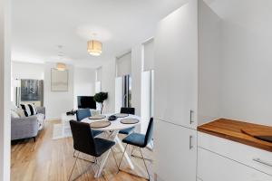 a kitchen and living room with a table and chairs at Luxury 2BR in Media City in Manchester +31 photos