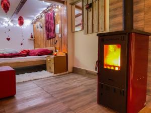 a room with a bed and a television in it at Home La Sierra with WHIRLPOOL BATH for two in Korenica +30 photos