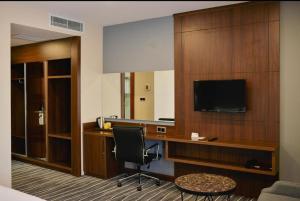 a hotel room with a desk and a television at Yalçın Resort Hotel in Korgan