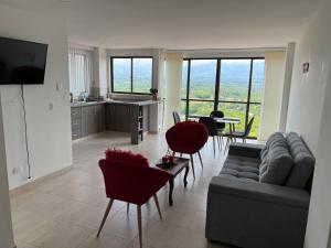 a living room with a couch and chairs and a table at Apartamento Vista Hermosa Parque del Café in Montenegro