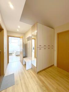a large room with white cabinets and wood floors at Old City Views - Luxury 2BDR Apt & Free Parking in Sofia