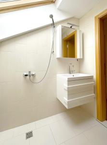 a white bathroom with a sink and a shower at Old City Views - Luxury 2BDR Apt & Free Parking in Sofia +28 photos