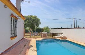 a swimming pool in the backyard of a house at Casa Ana in Conil de la Frontera