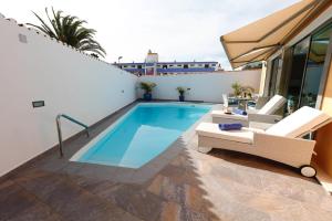 a swimming pool on the roof of a house at Villa ArenaMar with private Pool in Playa del Ingles