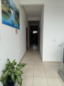 an empty hallway with a potted plant in a building at Hotel SANTA CLARA in Belém