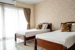 Postel nebo postele na pokoji v ubytování Alisa Krabi Hotel-SHA Plus