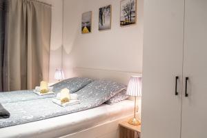 a bedroom with a bed with two lamps on it at Address Apartment Sarajevo in Sarajevo