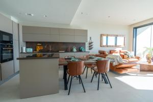 a kitchen and living room with a table and a couch at Oasis on the 27th, Mercury Tower in St Julian's