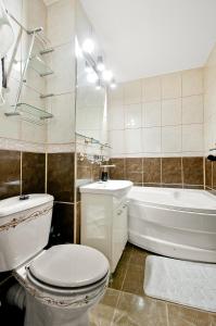 a bathroom with a toilet and a tub and a sink at Ultracentral Apartment Braila in Brăila