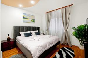 a bedroom with a large bed and a window at Ultracentral Apartment Braila in Brăila