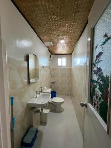 a bathroom with a sink and a toilet at Princesa Michaella Hostel in Itaytay +35 photos
