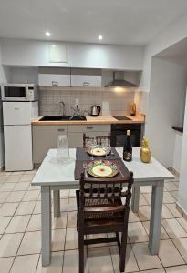a kitchen with a table with a plate on it at Appartement au cœur de Marcillac-Vallon in Marcillac-Vallon