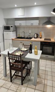 a kitchen with a table and a bench in it at Appartement au cœur de Marcillac-Vallon in Marcillac-Vallon +13 photos