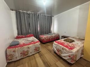 a room with two beds and a window at Hotel PALLACE in Belém