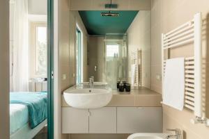 a bathroom with a sink and a mirror at YCH-Colosseo book house in Rome +18 photos