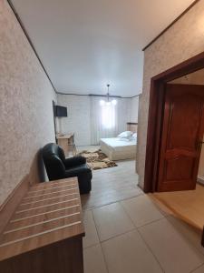 a room with a couch and a bed and a door at Casa Central in Tîrgu Neamţ