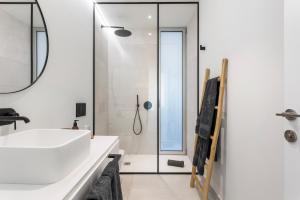 a bathroom with a white sink and a shower at LuxLiving Tenerife Villa Balansa in Adeje +15 photos
