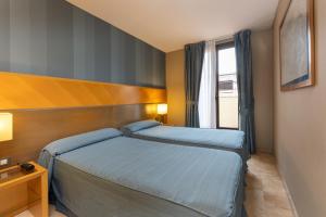 เตียงในห้องที่ Hotel del Mar