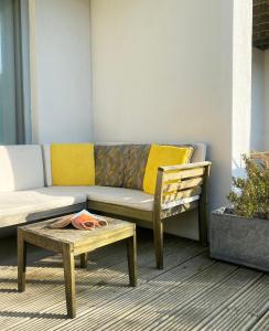 a couch and a chair and a coffee table at Eco Friendly beach house in Camber