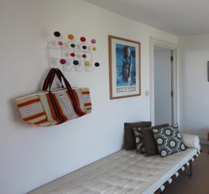 a living room with a white couch and some pillows at Eco Friendly beach house in Camber