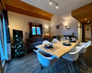 a dining room with a table and a christmas tree at Chalets d'Angèle D5 - T3 Cosy à Châtel in Châtel +11 photos