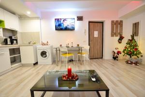 a living room with a christmas tree and a table at CityScape Bucharest in Bucharest