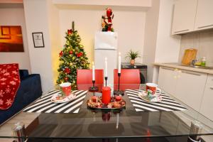 a dining room table with a christmas tree in the background at CityScape Bucharest in Bucharest