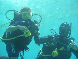 two people in the water with diver equipment at Villaggio Hotel Lido San Giuseppe in Briatico