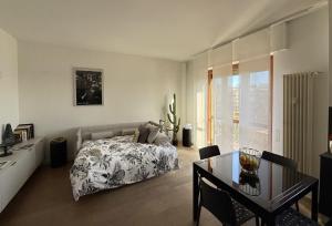 a bedroom with a bed and a table and a desk at LA TERRAZZA VISTA DUOMO, piscina e campi da tennis in Milan +14 photos