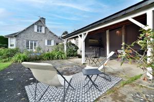 a group of chairs sitting outside of a house at Le Clos Marin - Belle maison avec Dépendance in Saint-Cast-le-Guildo