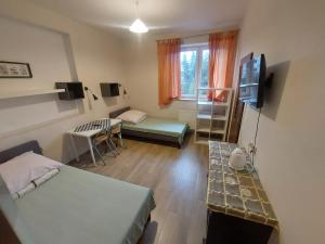 a small room with two beds and a television at Pokoje Hotelowe Noclegi Hotel Pensjonat Venus Siedlce in Siedlce