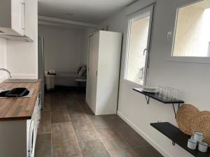 a kitchen with a white refrigerator and a window at Gómez-Tortosa Apartamento in Novelda