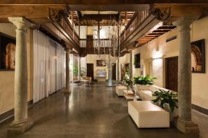 a lobby with columns and couches in a building at Gar Anat Hotel Boutique in Granada