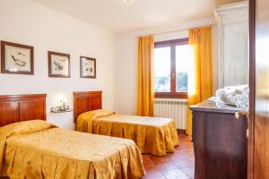 Postel nebo postele na pokoji v ubytování Agriturismo Bio Fattoria Casetta