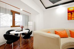 a living room with a couch and a table and chairs at Ultracentral Apartment Braila in Brăila +4 photos
