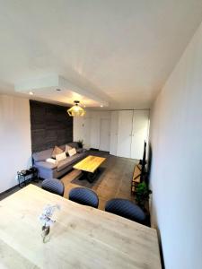 a living room with a couch and a table at Bel appartement Lagny sur Marne in Lagny
