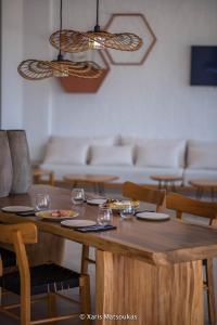 a dining room with a wooden table and chairs at Ilios Suites in Kato Gouves