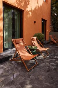 two chairs sitting on a patio next to a building at EZE BEACH Residence in Éze