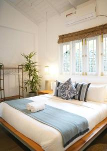 a bedroom with a large bed with pillows at Shaka Villa in Dickwella +44 photos