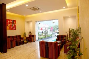 a waiting room with red chairs and a window at Le Roi Udaipur in Udaipur