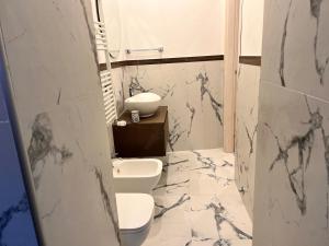 a bathroom with a toilet and a sink at La Casetta del Vicolo in La Spezia +32 photos