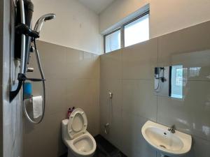 a bathroom with a toilet and a sink at Seaside 4 Bedroom House at PD by MAISON in Port Dickson +17 photos
