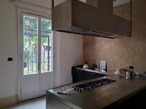 a kitchen with a stove top oven next to a door at la villa dell'orologio in Santa Croce sullʼ Arno