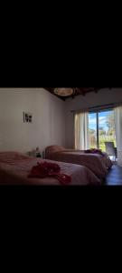 a bedroom with two beds and a window at Casa mar chiquita in Mar del Plata