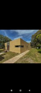 two pictures of a building in front at Casa mar chiquita in Mar del Plata