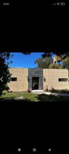 a view of a building with a large doorway at Casa mar chiquita in Mar del Plata +4 photos