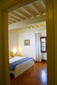 a bedroom with a bed in a room with a ceiling at Maison B in Prato