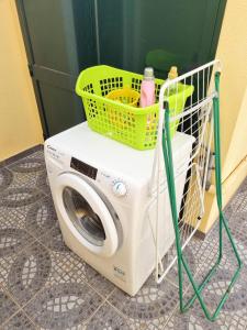 a washing machine with a basket on top of it at Villa Atlântico, your family&friends retreat in Ponta do Sol